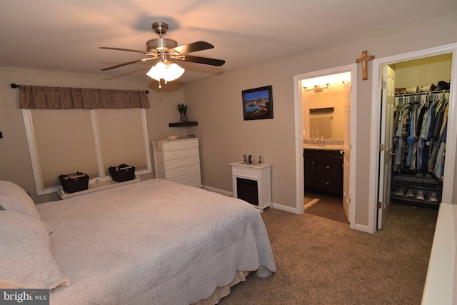 359 Eagle Way, Smyrna, DE 19977 - carpeted bedroom featuring a walk in closet, a sink, connected bathroom, a closet, and a ceiling fan