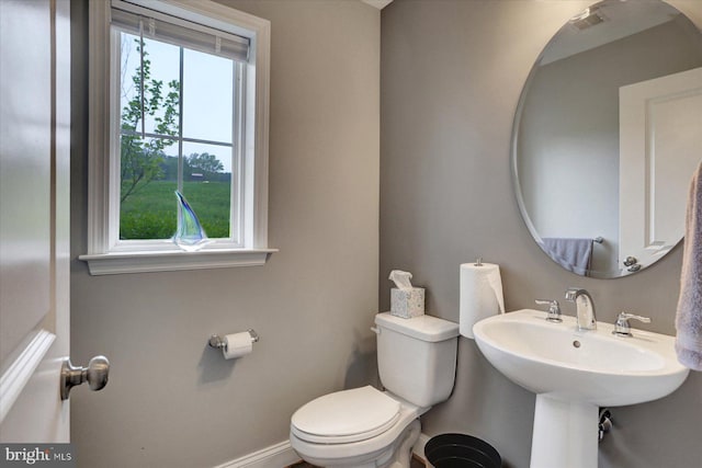 3118 Grove Ct, Mechanicsburg, PA 17055 - half bath with plenty of natural light, toilet, baseboards, and a sink