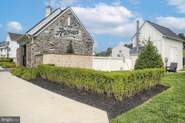 3118 Grove Ct, Mechanicsburg, PA 17055 - view of side of home with a chimney, a standing seam roof, board and batten siding, stone siding, and metal roof