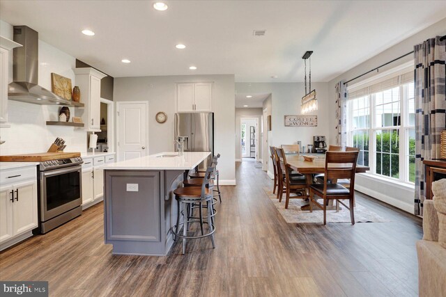 3118 Grove Ct, Mechanicsburg, PA 17055 - kitchen with appliances with stainless steel finishes, wall chimney exhaust hood, dark wood finished floors, plenty of natural light, and recessed lighting