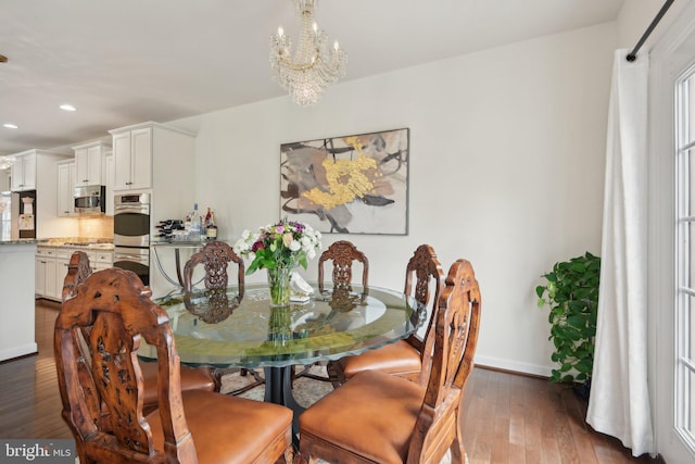 dining area featuring a chandelier, dark wood-style flooring, baseboards, and recessed lighting