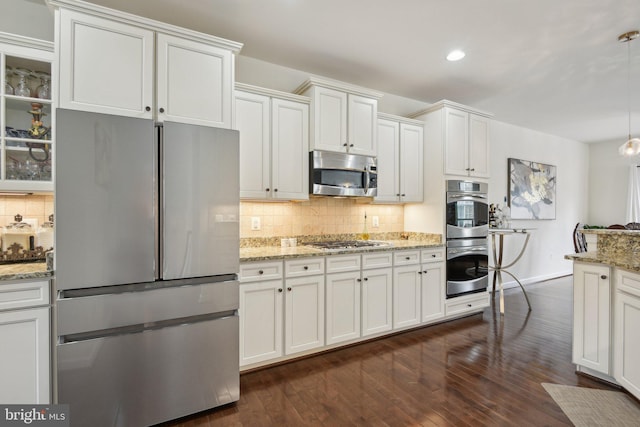 kitchen featuring stainless steel appliances, decorative backsplash, glass insert cabinets, dark wood-style flooring, and recessed lighting
