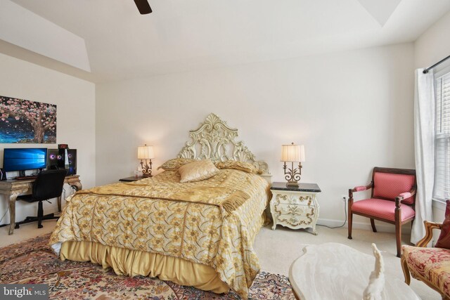 carpeted bedroom featuring a desk, vaulted ceiling, a ceiling fan, and baseboards