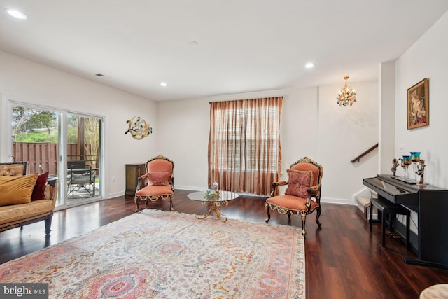 living area with wood finished floors, recessed lighting, baseboards, and a chandelier