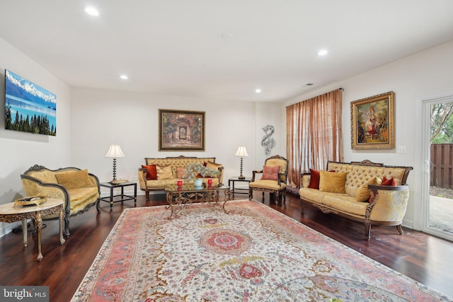 living room with dark wood-type flooring and recessed lighting
