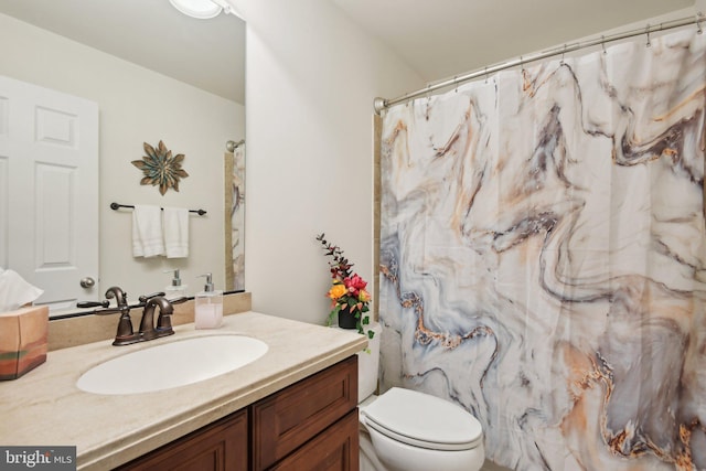 full bath featuring vanity and toilet