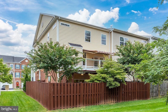 rear view of property featuring fence