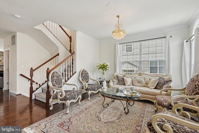 living room with wood finished floors, stairway, and ornamental molding