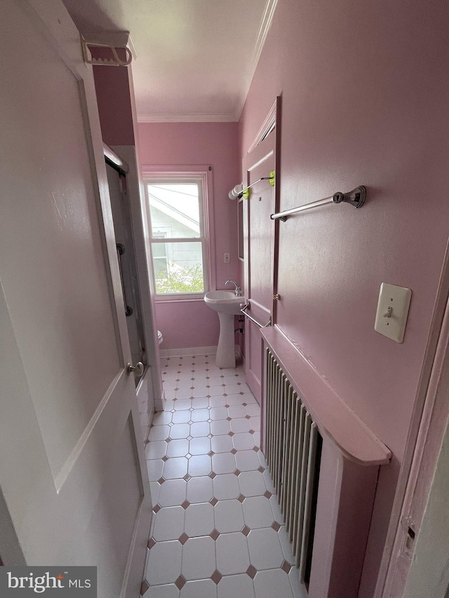 full bath featuring tile patterned floors, a shower with shower door, ornamental molding, toilet, and a sink