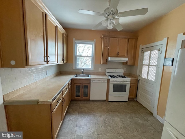 kitchen featuring white appliances, under cabinet range hood, a sink, ceiling fan, and light countertops
