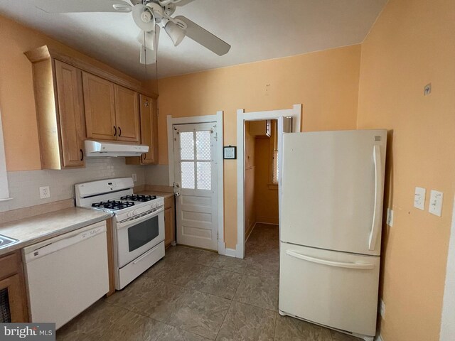 kitchen featuring white appliances, under cabinet range hood, a ceiling fan, light countertops, and light tile patterned flooring