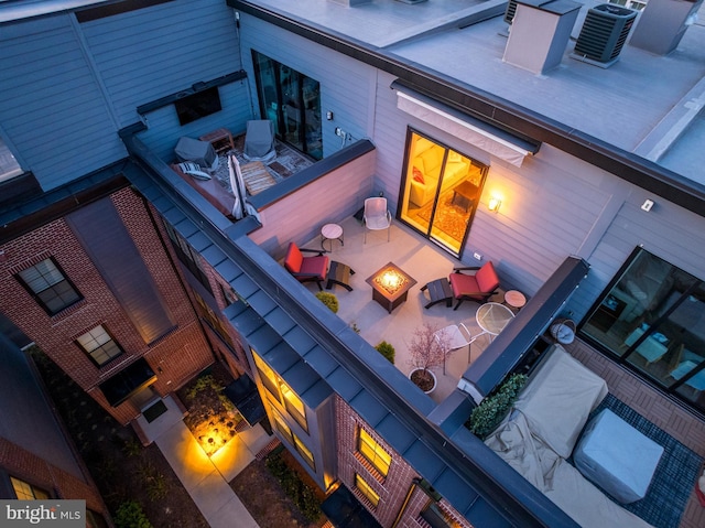 11244 Faraday Park Dr, Reston, VA 20190 - back of property with central AC, a fire pit, and a patio