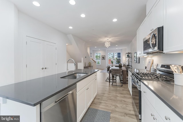 11244 Faraday Park Dr, Reston, VA 20190 - kitchen with appliances with stainless steel finishes, a sink, recessed lighting, white cabinetry, and light wood-style flooring