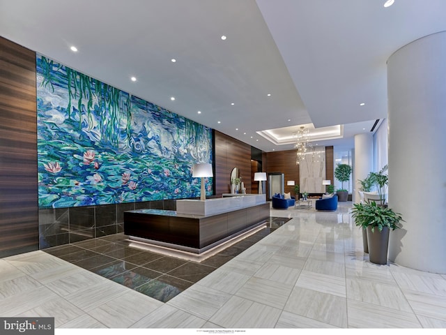 welcome area with a chandelier and recessed lighting