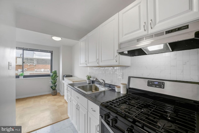 1601 18th St NW Unit 1015, Washington, DC 20009 - kitchen with stainless steel range with gas cooktop, a sink, under cabinet range hood, white cabinets, and decorative backsplash