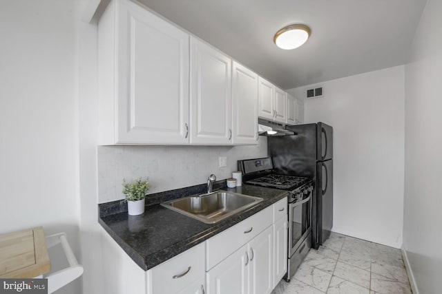 1601 18th St NW Unit 1015, Washington, DC 20009 - kitchen with gas stove, a sink, under cabinet range hood, light marble finish flooring, and baseboards