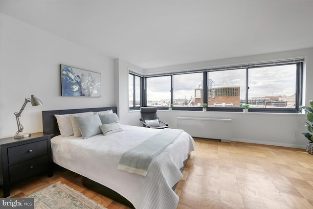 1601 18th St NW Unit 1015, Washington, DC 20009 - bedroom featuring radiator heating unit, multiple windows, and baseboards