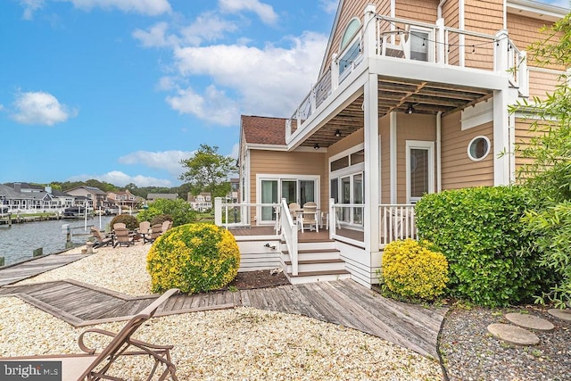 18 Ebb Tide Ct, Ocean Pines, MD 21811 - view of front facade with a patio, a deck with water view, and a balcony