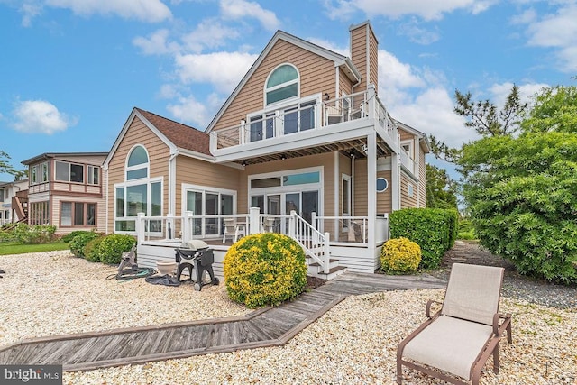 18 Ebb Tide Ct, Ocean Pines, MD 21811 - back of house featuring a balcony and a chimney