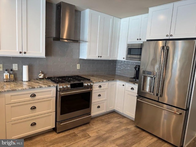 18 Ebb Tide Ct, Ocean Pines, MD 21811 - kitchen featuring appliances with stainless steel finishes, wall chimney range hood, and white cabinetry