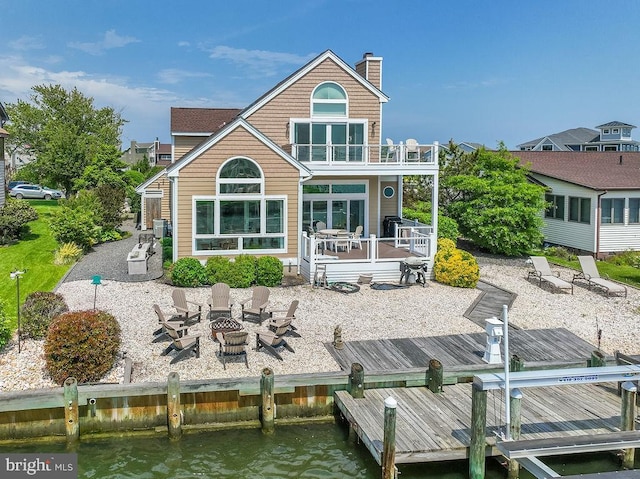 18 Ebb Tide Ct, Ocean Pines, MD 21811 - back of house with a fire pit, a balcony, a patio, a chimney, and a deck with water view