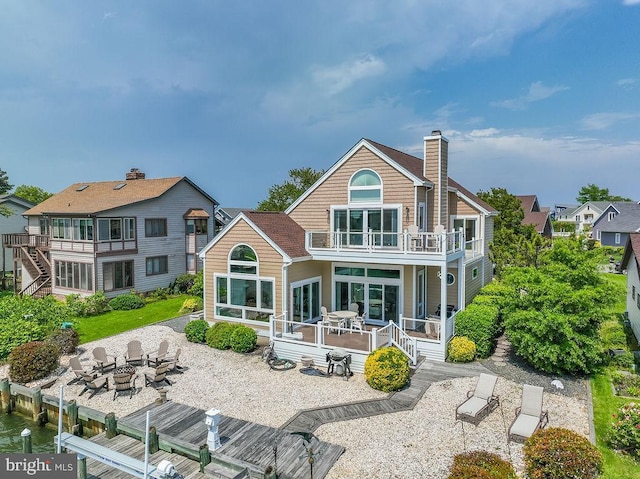 18 Ebb Tide Ct, Ocean Pines, MD 21811 - back of house featuring a balcony, an outdoor fire pit, a patio area, a chimney, and a wooden deck