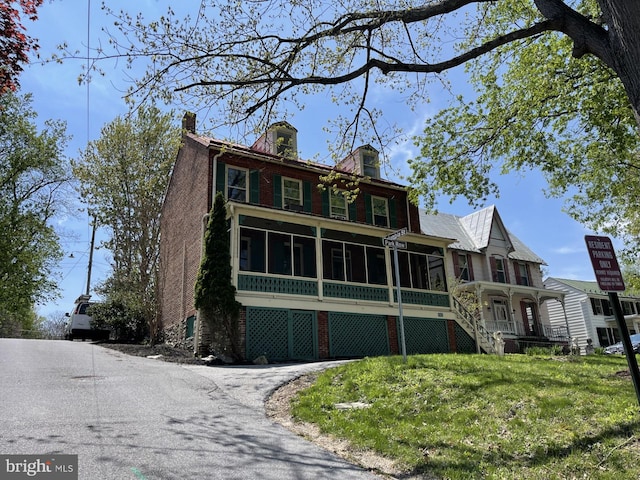 501 Park Row Pl, Harpers Ferry, WV 25425 - view of front facade featuring a sunroom and a chimney