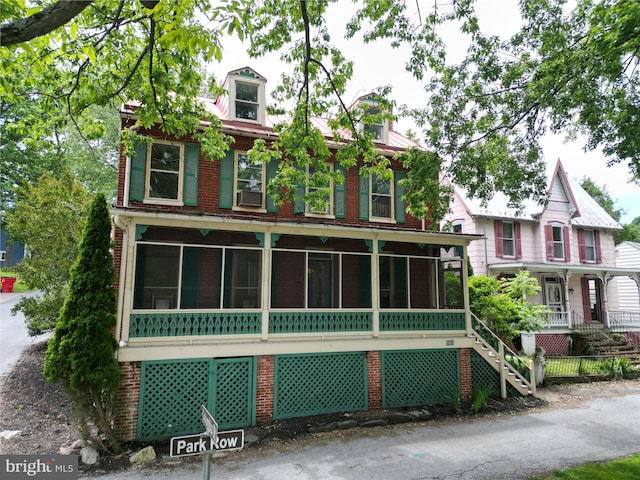 501 Park Row Pl, Harpers Ferry, WV 25425 - victorian home with brick siding, a sunroom, and covered porch