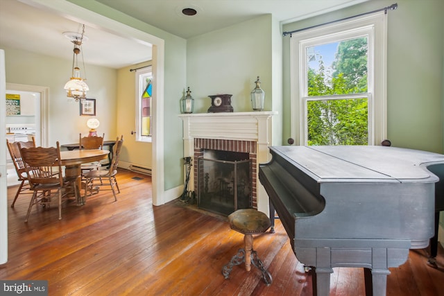 501 Park Row Pl, Harpers Ferry, WV 25425 - dining area featuring healthy amount of natural light, hardwood / wood-style floors, and a brick fireplace