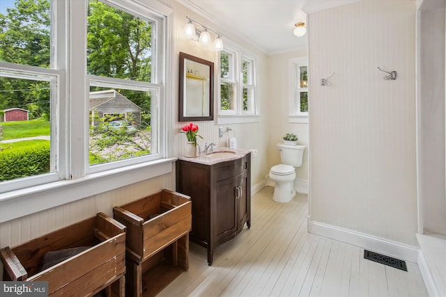 501 Park Row Pl, Harpers Ferry, WV 25425 - bathroom with vanity, toilet, baseboards, hardwood / wood-style floors, and ornamental molding