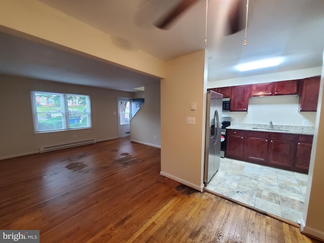 117 S Shenandoah Ave, Front Royal, VA 22630 - kitchen featuring baseboard heating, a sink, light wood finished floors, appliances with stainless steel finishes, and dark brown cabinets