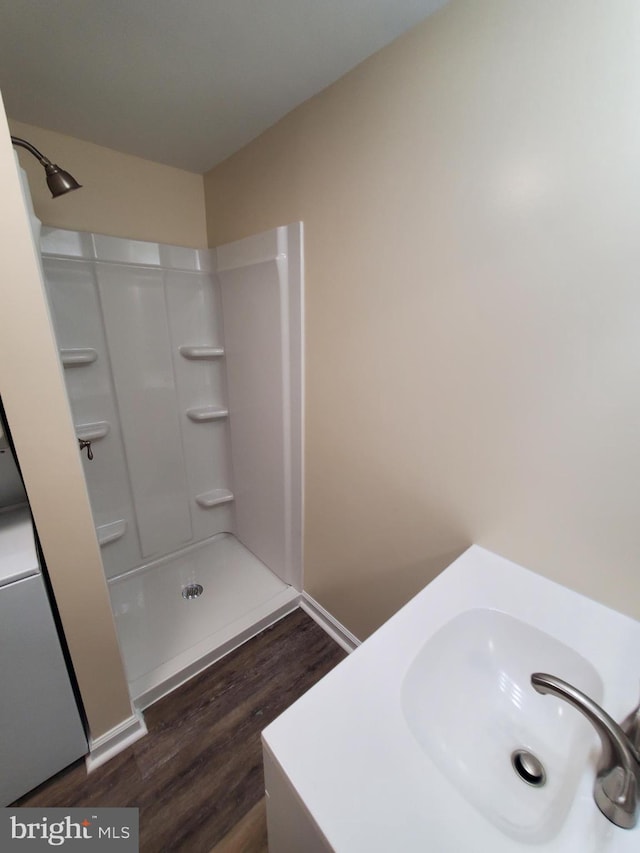 117 S Shenandoah Ave, Front Royal, VA 22630 - bathroom with wood finished floors, a shower, and a sink