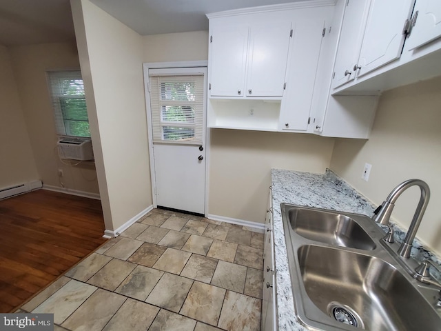 117 S Shenandoah Ave, Front Royal, VA 22630 - kitchen featuring a sink, light countertops, white cabinetry, baseboards, and cooling unit