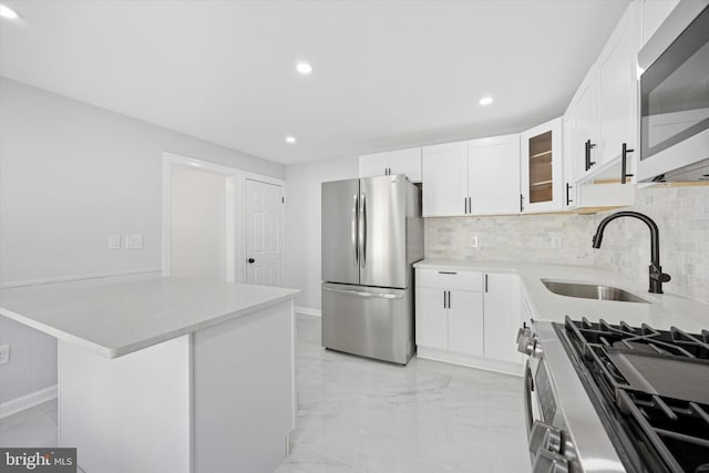 329 Euclid Ave, Trenton, NJ 08609 - kitchen featuring stainless steel appliances, a sink, decorative backsplash, glass insert cabinets, and recessed lighting