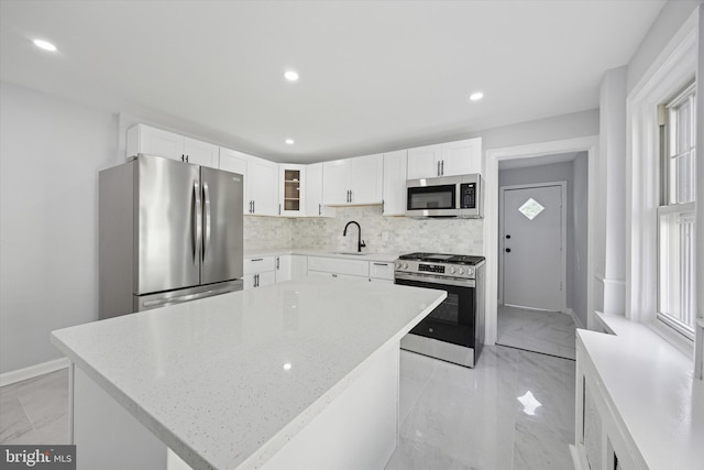 329 Euclid Ave, Trenton, NJ 08609 - kitchen with stainless steel appliances, light marble finish floors, tasteful backsplash, white cabinets, and recessed lighting