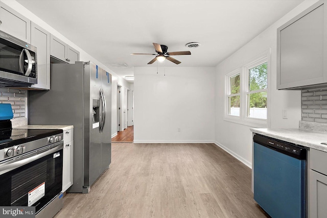 104 Louise Ave, Salisbury, MD 21804 - kitchen featuring stainless steel appliances, tasteful backsplash, ceiling fan, light wood-style flooring, and light countertops