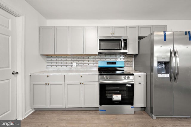 104 Louise Ave, Salisbury, MD 21804 - kitchen featuring appliances with stainless steel finishes, light countertops, light wood finished floors, and decorative backsplash