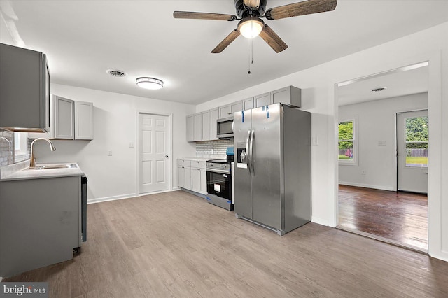104 Louise Ave, Salisbury, MD 21804 - kitchen with stainless steel appliances, gray cabinetry, a sink, and light wood finished floors
