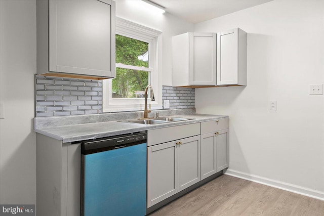104 Louise Ave, Salisbury, MD 21804 - kitchen with dishwashing machine, a sink, decorative backsplash, light wood-style floors, and light countertops