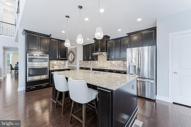 23412 Longollen Woods Ter, Ashburn, VA 20148 - kitchen with appliances with stainless steel finishes, dark wood-style flooring, a sink, light stone counters, and baseboards