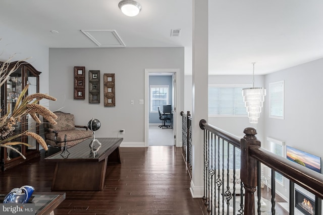 23412 Longollen Woods Ter, Ashburn, VA 20148 - living area with wood finished floors, baseboards, and a chandelier