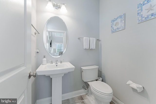 23412 Longollen Woods Ter, Ashburn, VA 20148 - half bathroom featuring toilet, baseboards, and a sink