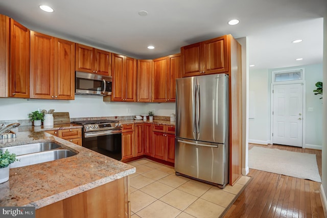 15 Todd Pl NE, Washington, DC 20002 - kitchen featuring appliances with stainless steel finishes, a sink, light stone countertops, recessed lighting, and brown cabinetry