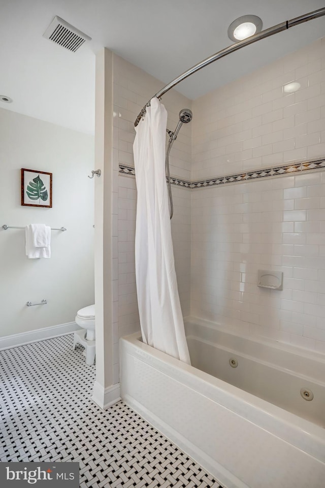 15 Todd Pl NE, Washington, DC 20002 - bathroom featuring a combined bath / shower with jetted tub, toilet, and baseboards