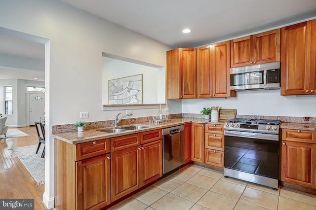 15 Todd Pl NE, Washington, DC 20002 - kitchen featuring appliances with stainless steel finishes, a sink, light stone counters, recessed lighting, and brown cabinetry