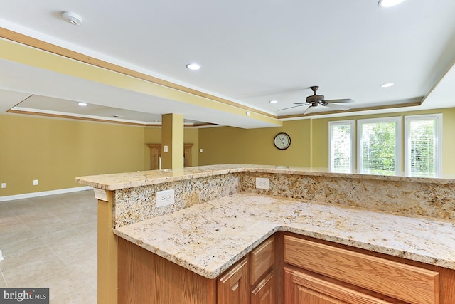 7808 Devereux Manor Ct, Fairfax Station, VA 22039 - kitchen featuring ceiling fan, recessed lighting, light stone countertops, baseboards, and a raised ceiling