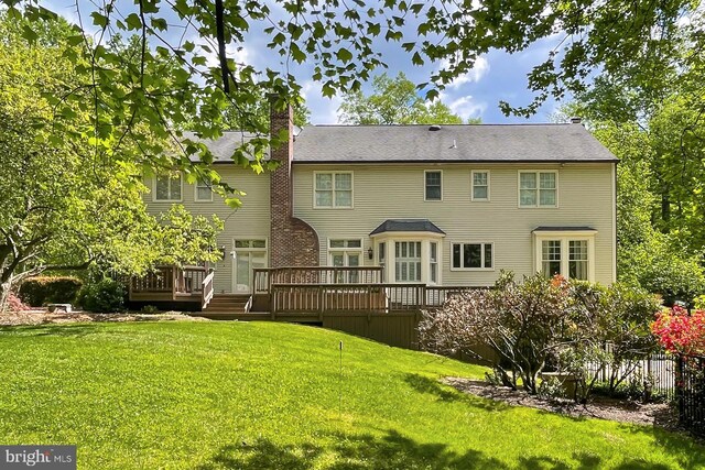 7808 Devereux Manor Ct, Fairfax Station, VA 22039 - back of house with a yard, a wooden deck, and a chimney