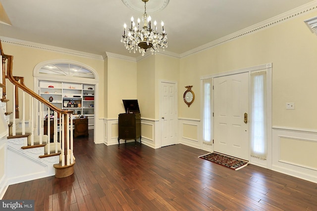 7808 Devereux Manor Ct, Fairfax Station, VA 22039 - entrance foyer featuring dark wood finished floors, a wainscoted wall, ornamental molding, a decorative wall, and a chandelier