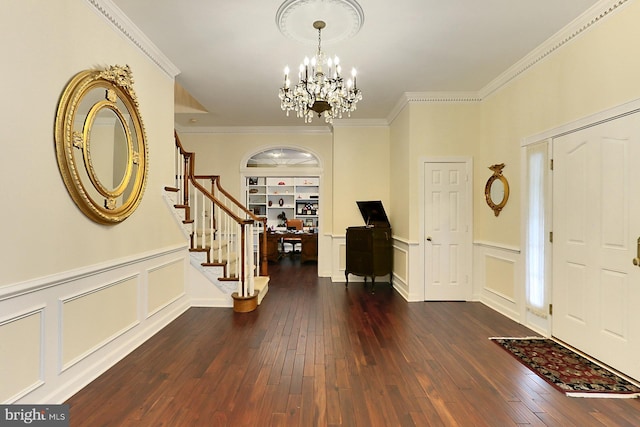 7808 Devereux Manor Ct, Fairfax Station, VA 22039 - entryway featuring stairway, a chandelier, a decorative wall, dark wood-type flooring, and crown molding
