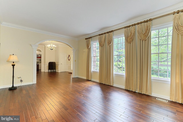 7808 Devereux Manor Ct, Fairfax Station, VA 22039 - spare room featuring arched walkways, dark wood-style flooring, ornamental molding, baseboards, and ornate columns